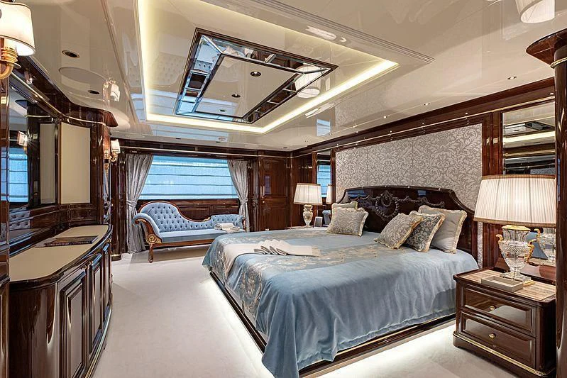 a bedroom with a large bed aboard LADY LENA Yacht for Sale