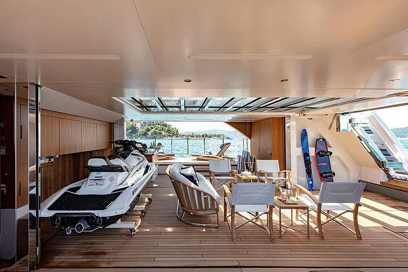 a large room with a pool table and chairs aboard LADY LENA Yacht for Sale