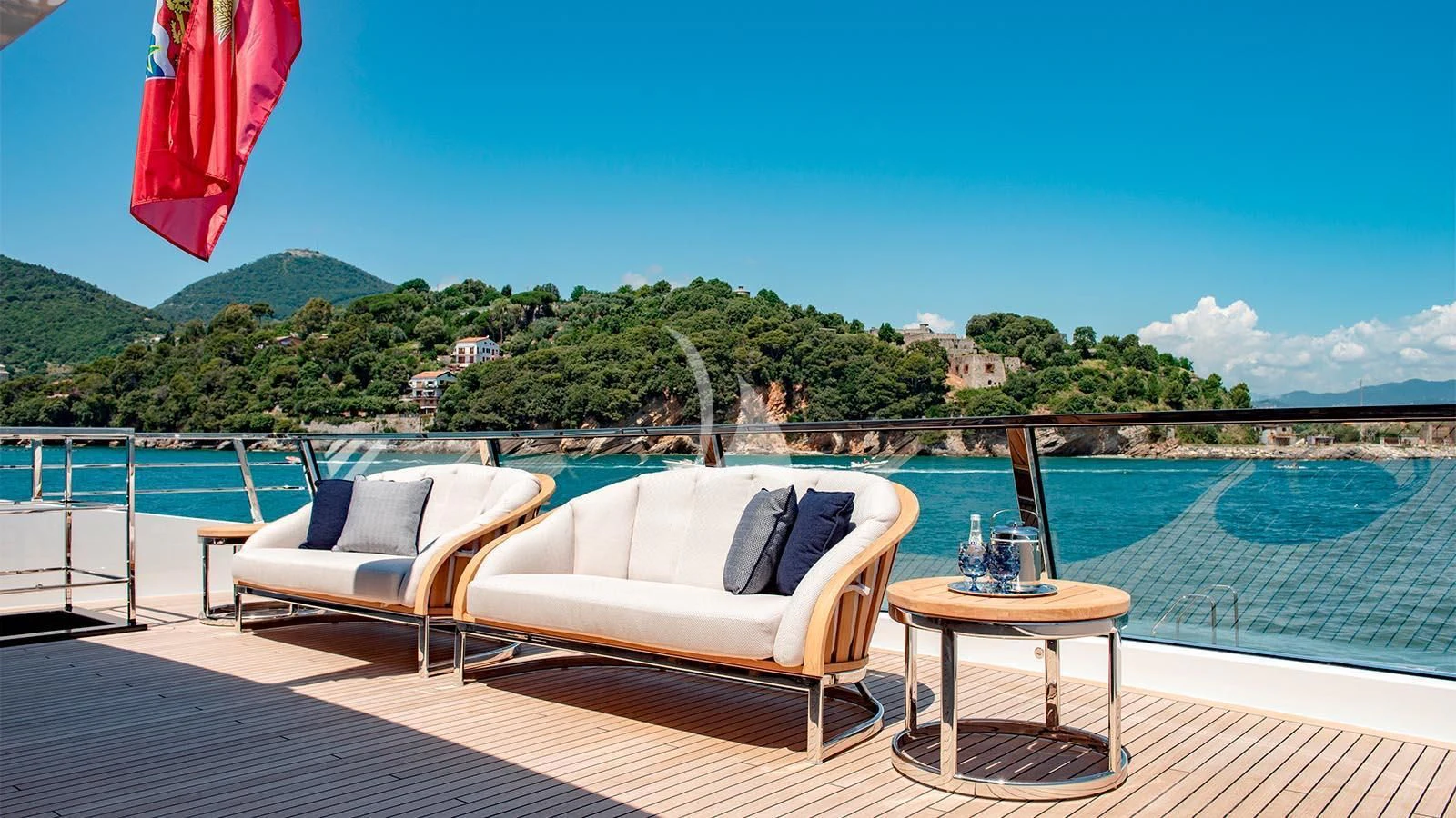 a couple of white couches on a deck overlooking a body of water aboard LADY LENA Yacht for Sale