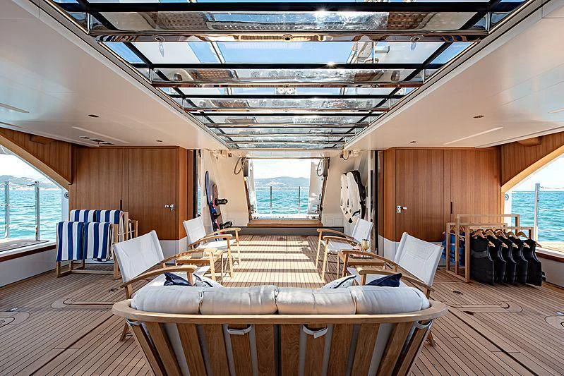 a large room with a wood floor aboard LADY LENA Yacht for Sale
