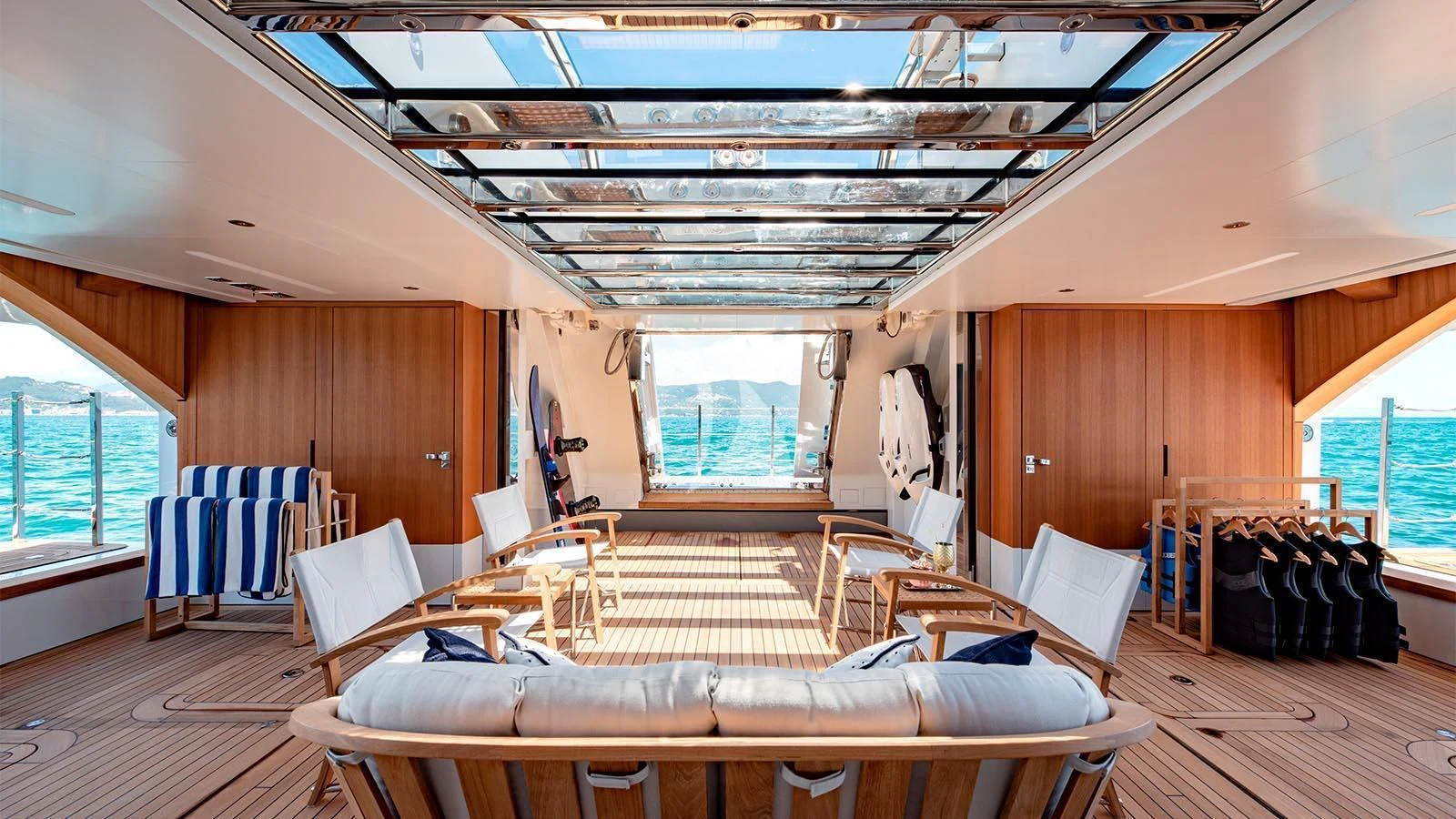 a room with a wood floor and a large window aboard LADY LENA Yacht for Sale