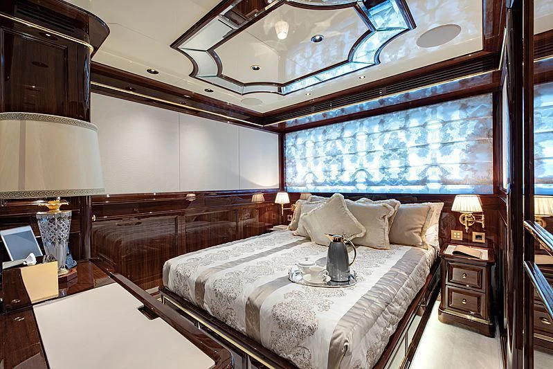 a bedroom with a large bed aboard LADY LENA Yacht for Sale