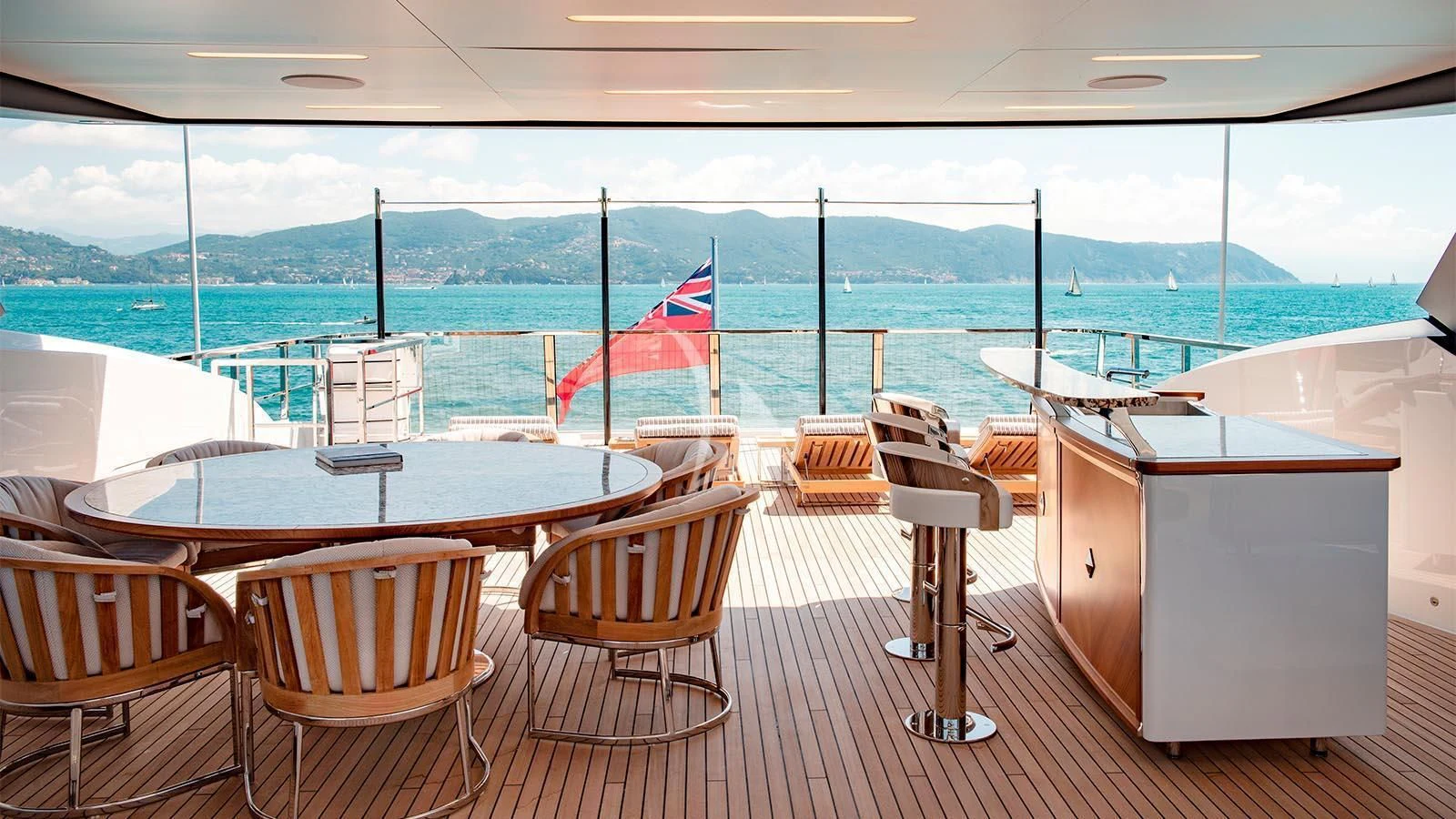 a room with tables and chairs aboard LADY LENA Yacht for Sale