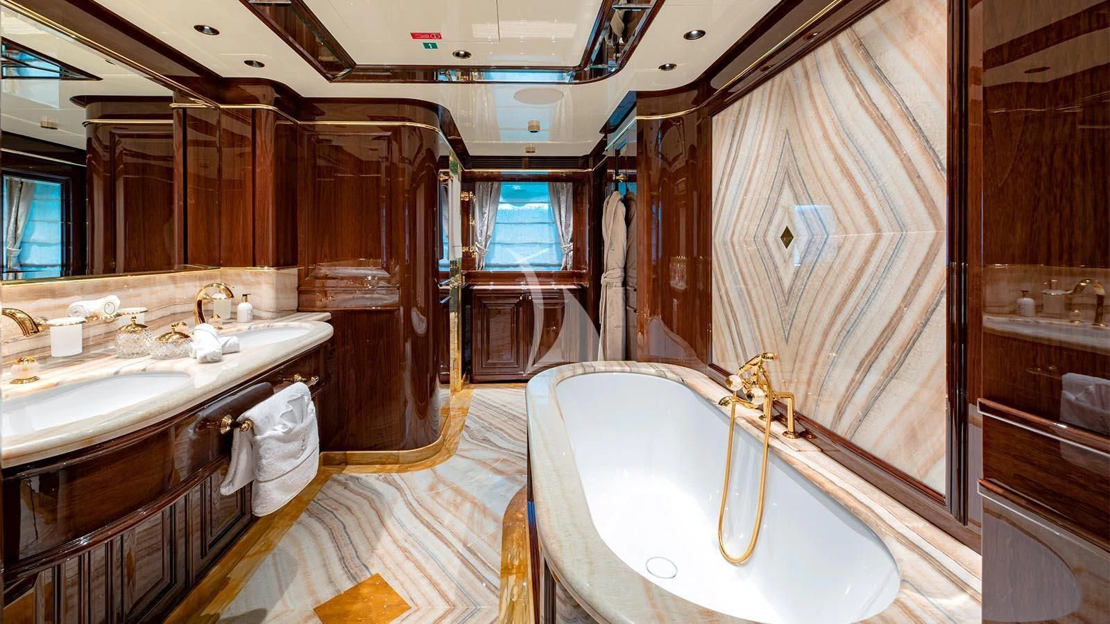 a bathroom with a tub sink and cabinets aboard LADY LENA Yacht for Sale