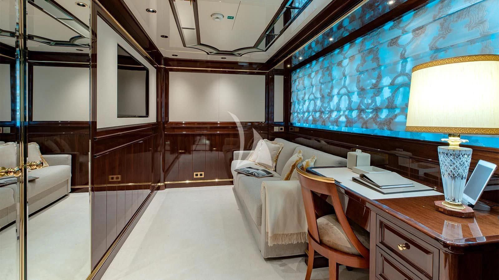 a room with a desk and a couch and a lamp aboard LADY LENA Yacht for Sale