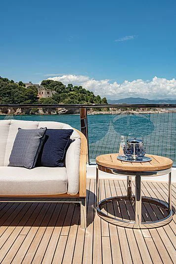 a table on a deck overlooking a body of water aboard LADY LENA Yacht for Sale