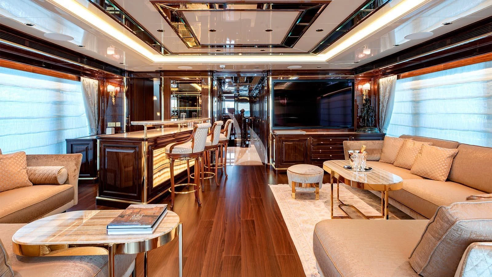 a living room with a wood floor aboard LADY LENA Yacht for Sale