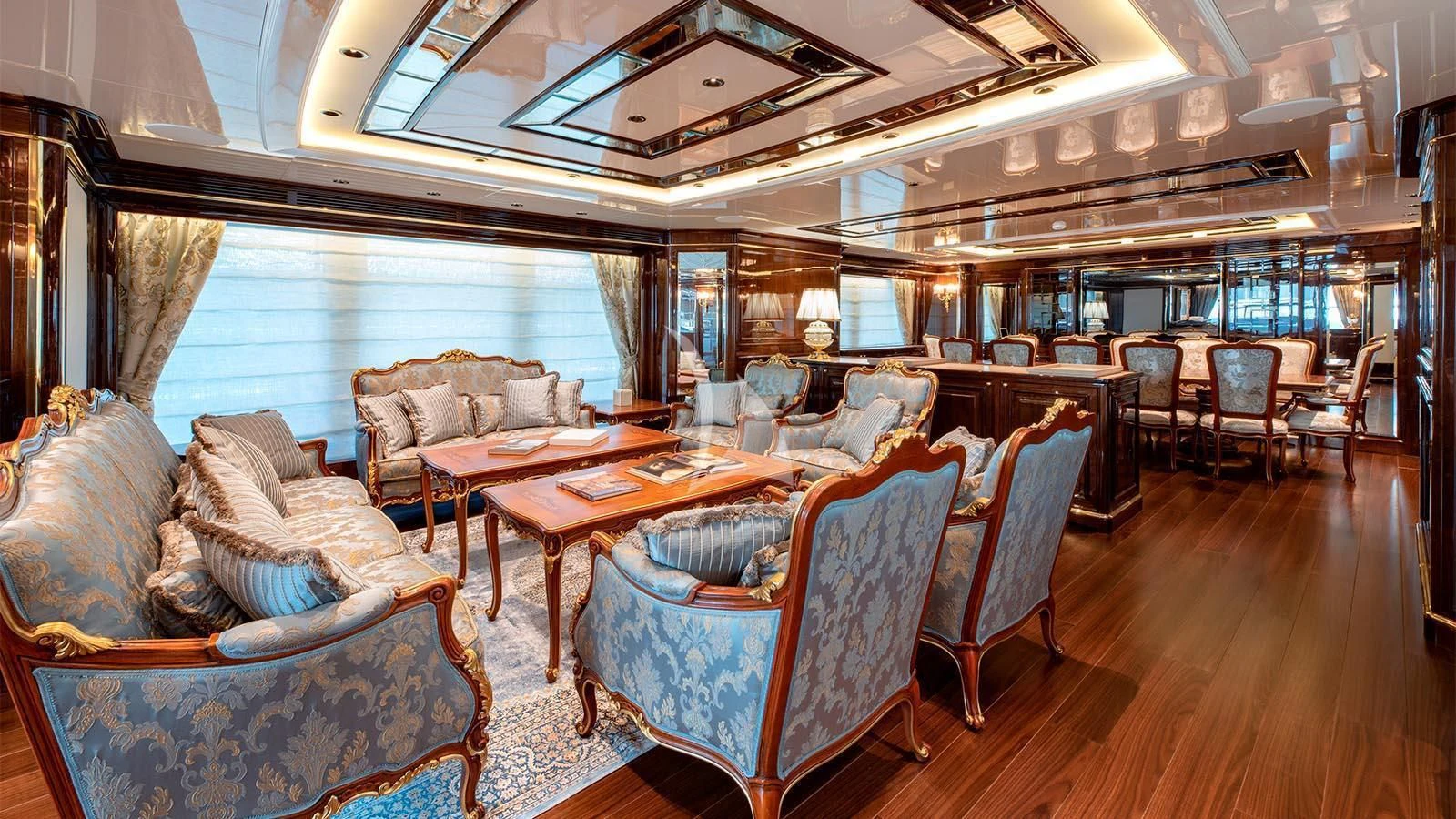 a large dining room with a wood floor aboard LADY LENA Yacht for Sale