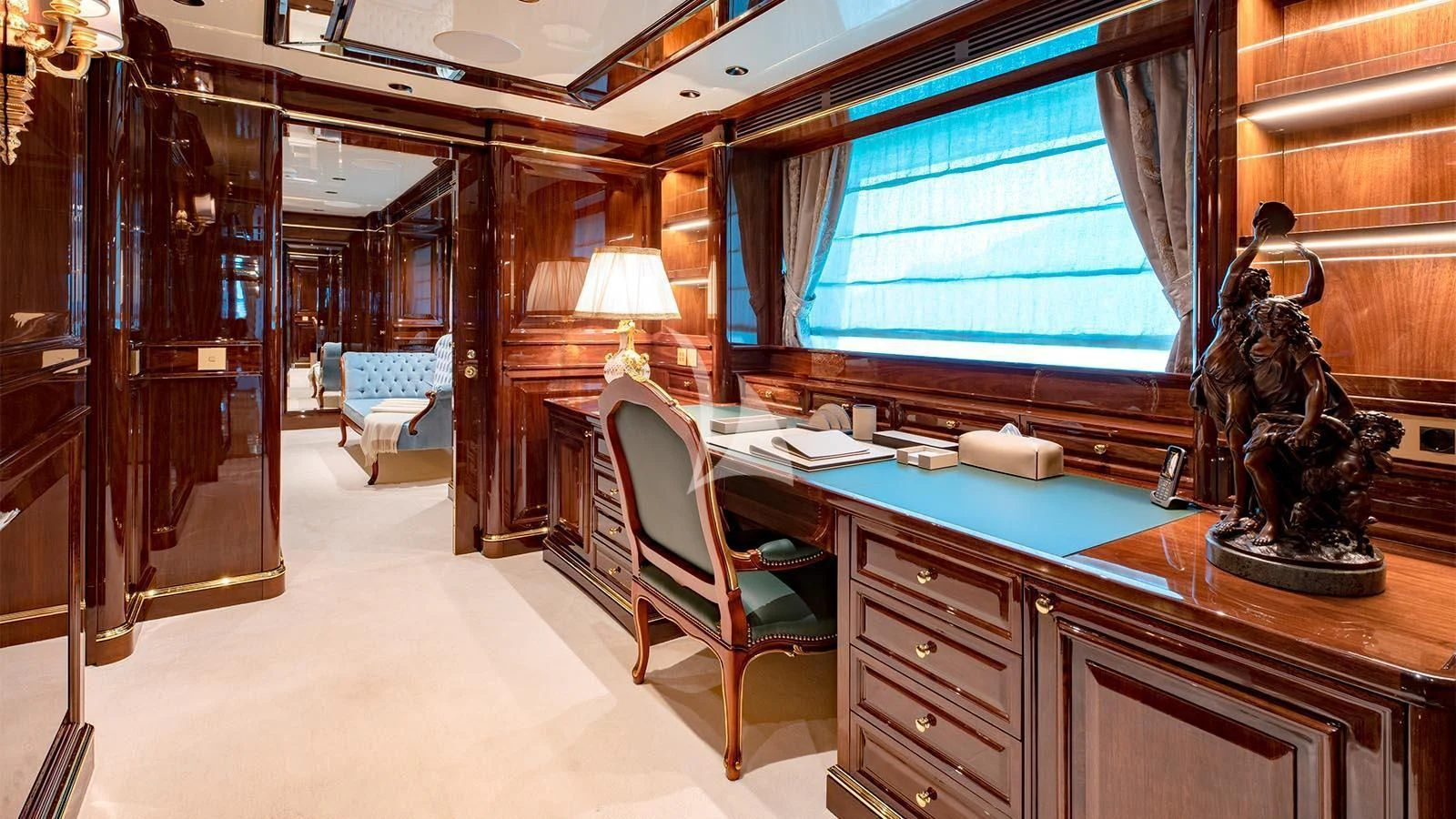 a room with a desk and a chair and a statue aboard LADY LENA Yacht for Sale
