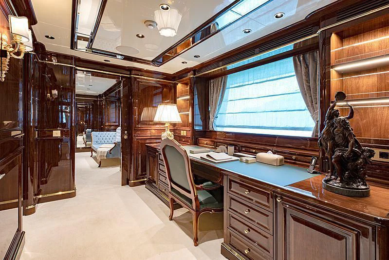 a room with a desk and a chair and a statue aboard LADY LENA Yacht for Sale
