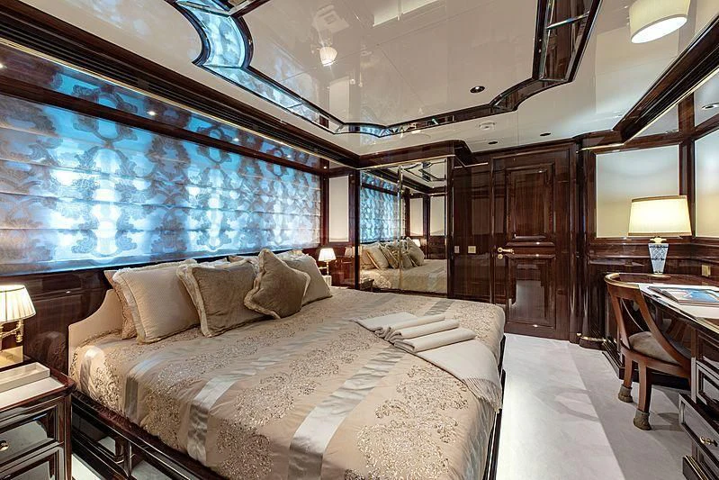 a large bedroom with a bed aboard LADY LENA Yacht for Sale