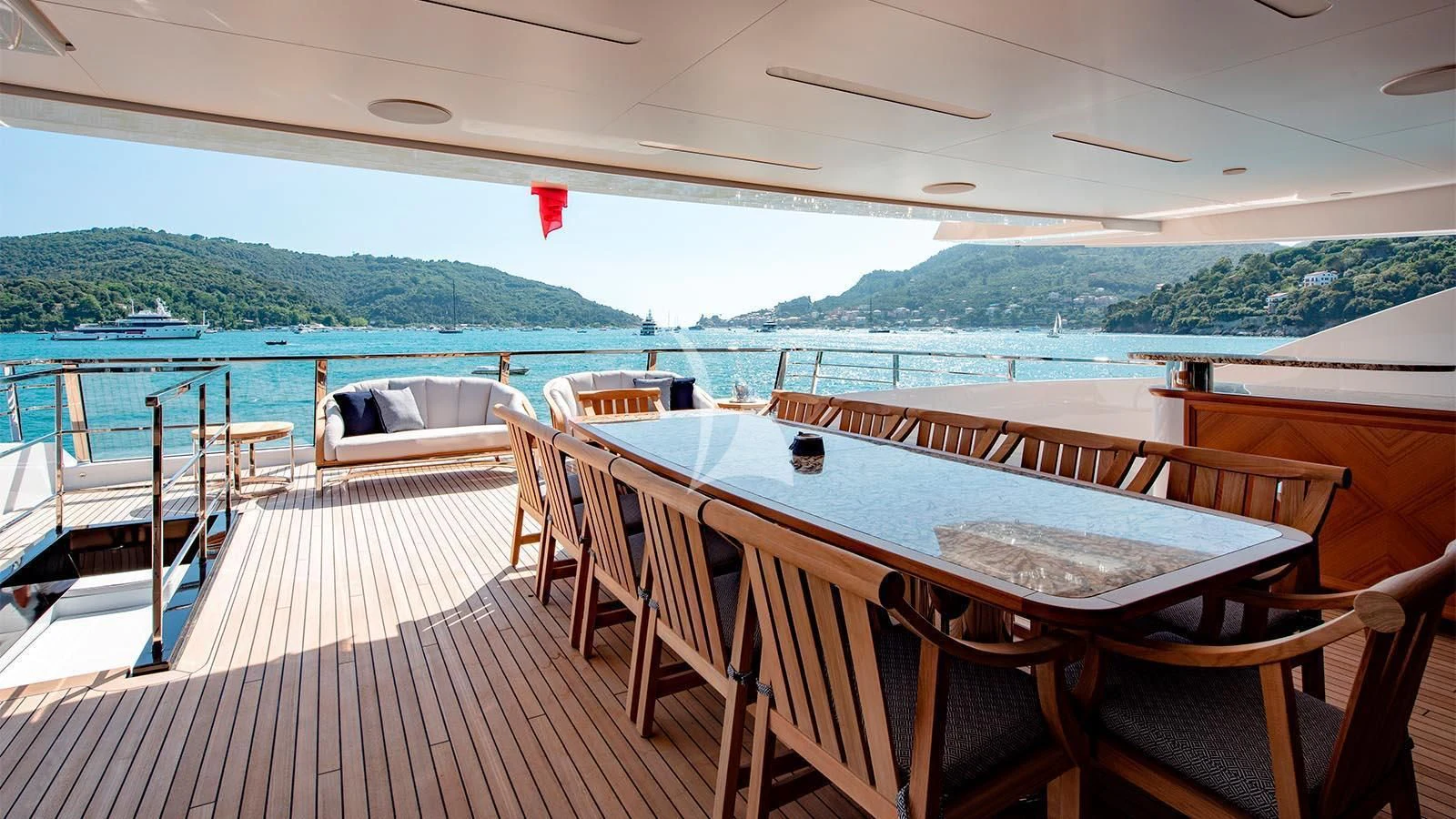a deck with a table and chairs on it aboard LADY LENA Yacht for Sale