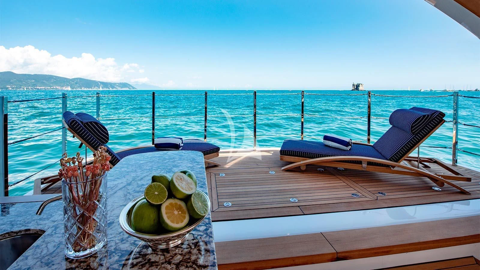 a table with a plate of limes and a bowl of limes on it aboard LADY LENA Yacht for Sale