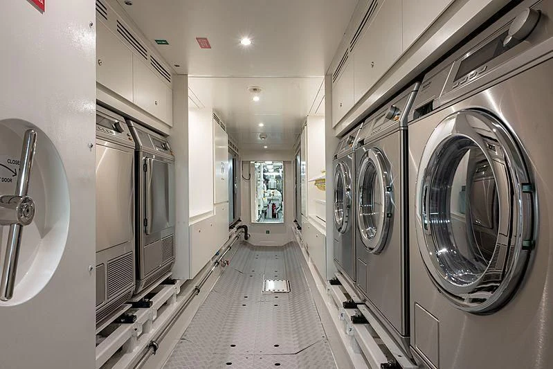 a long hallway with white walls aboard LADY LENA Yacht for Sale
