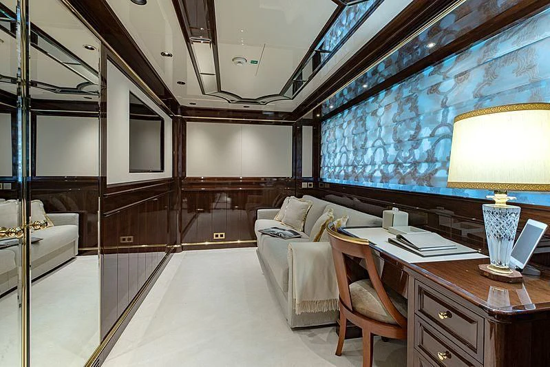 a room with a couch and a table and a lamp aboard LADY LENA Yacht for Sale