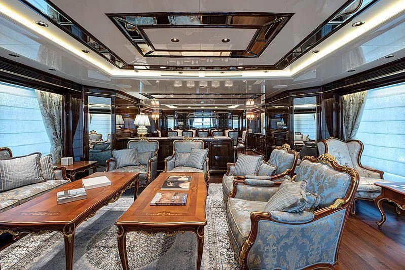 a living room with a table and chairs aboard LADY LENA Yacht for Sale