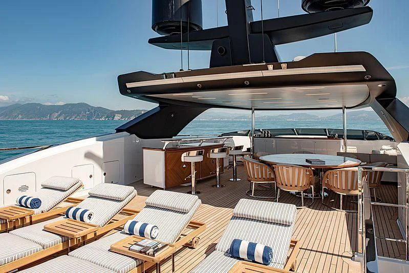 a deck with a large boat on it and a deck with chairs and tables on it aboard LADY LENA Yacht for Sale