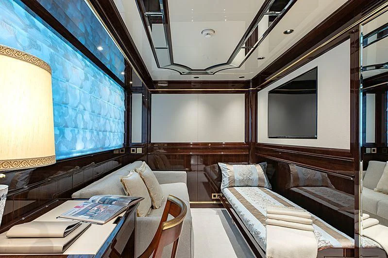 a room with a bed and a table aboard LADY LENA Yacht for Sale