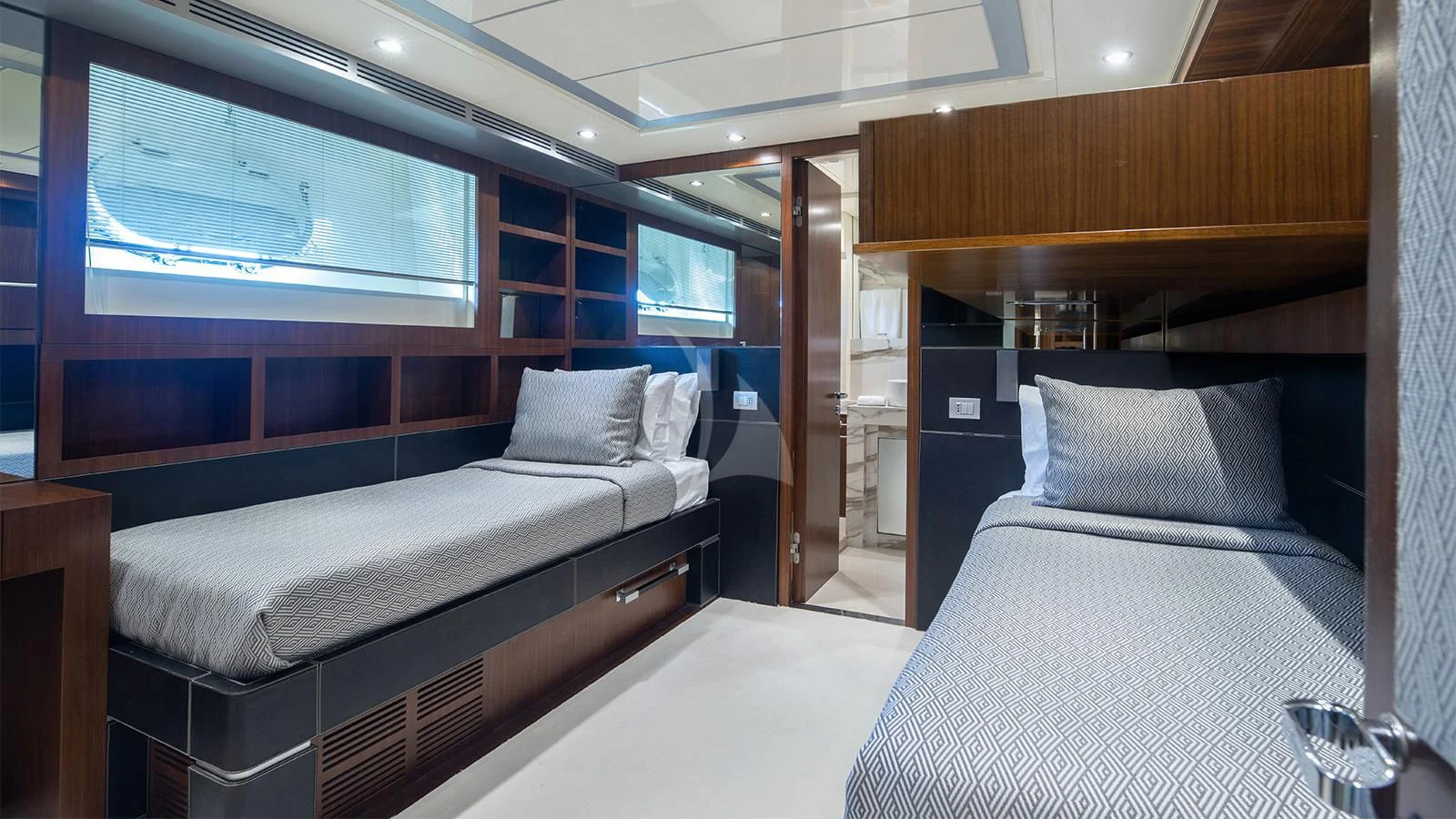 a room with beds and a window aboard BEYOND Yacht for Charter