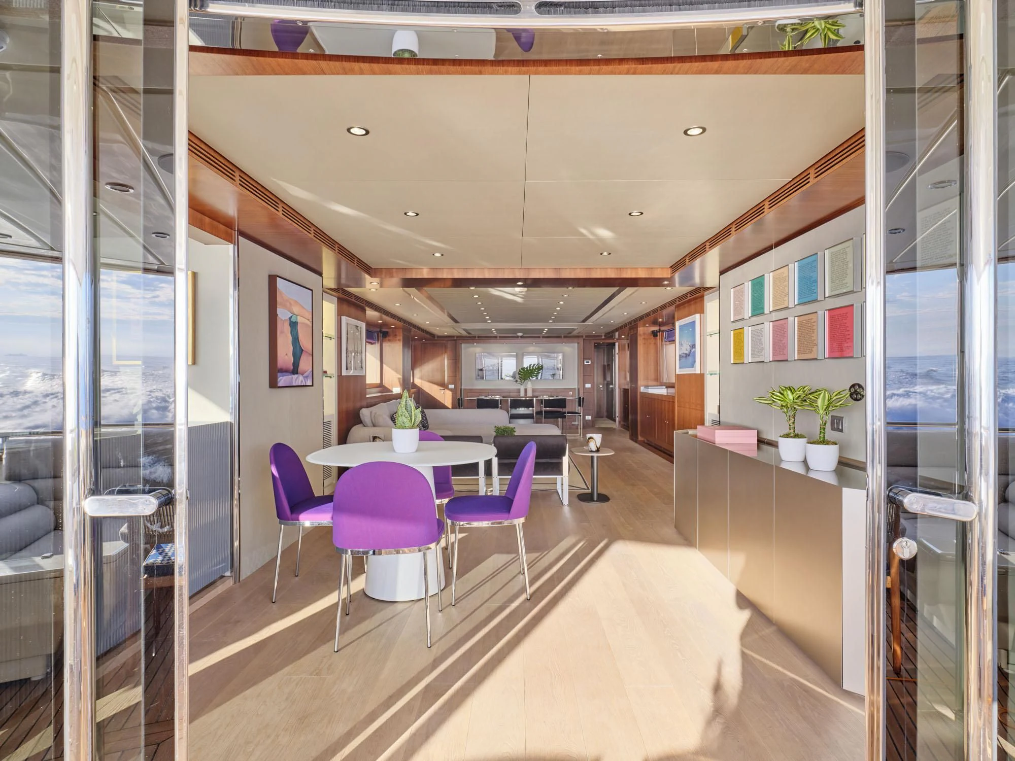 a room with a table and chairs aboard BEYOND Yacht for Charter