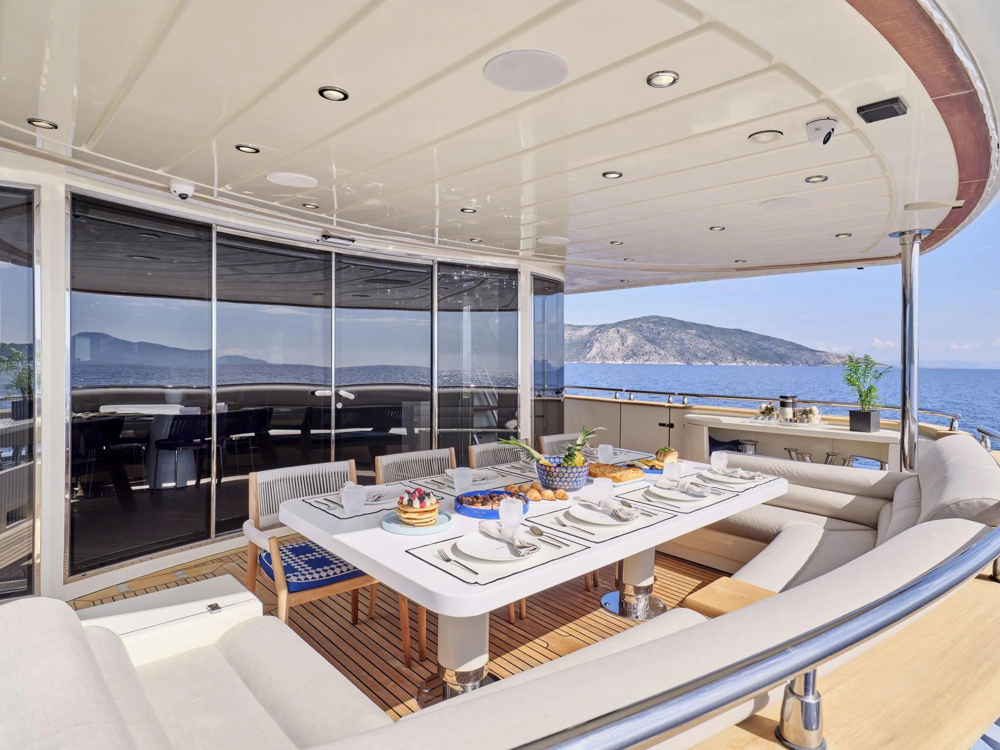 a room with a table and chairs aboard BEYOND Yacht for Charter