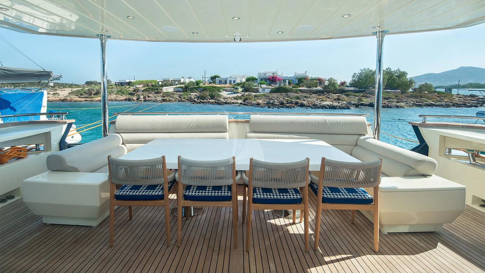 a table and chairs on a deck aboard BEYOND Yacht for Charter