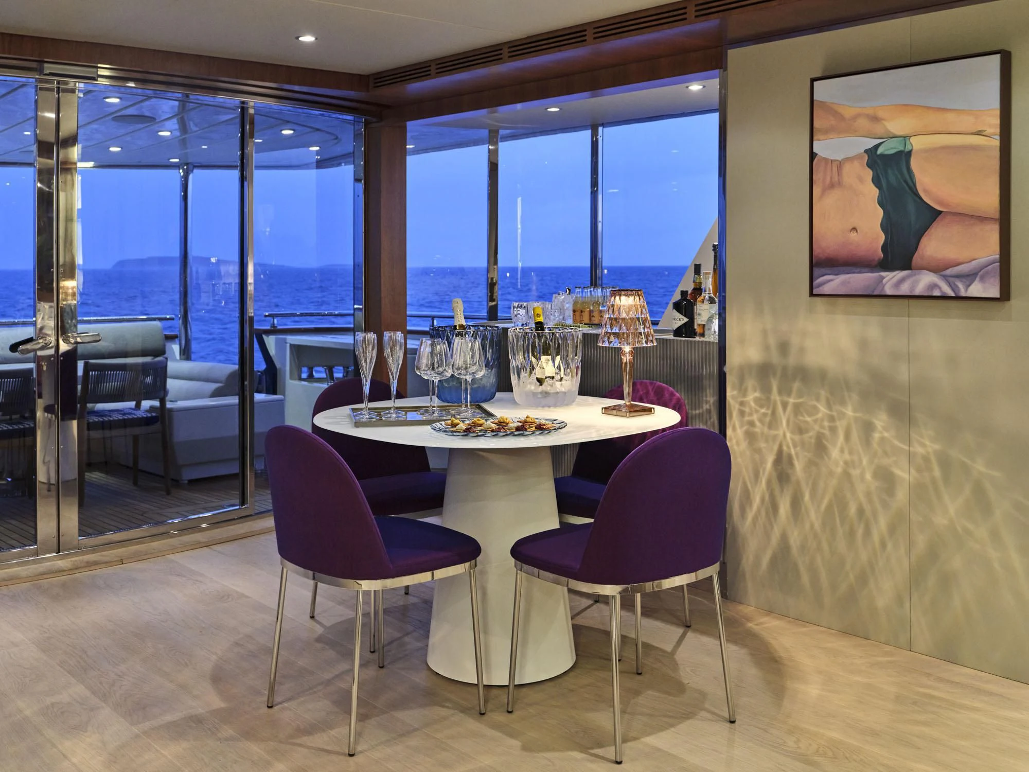 a table with wine glasses on it aboard BEYOND Yacht for Charter