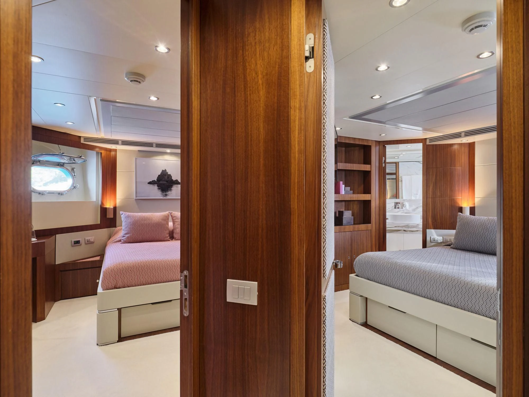 a room with a bed and a desk aboard BEYOND Yacht for Charter