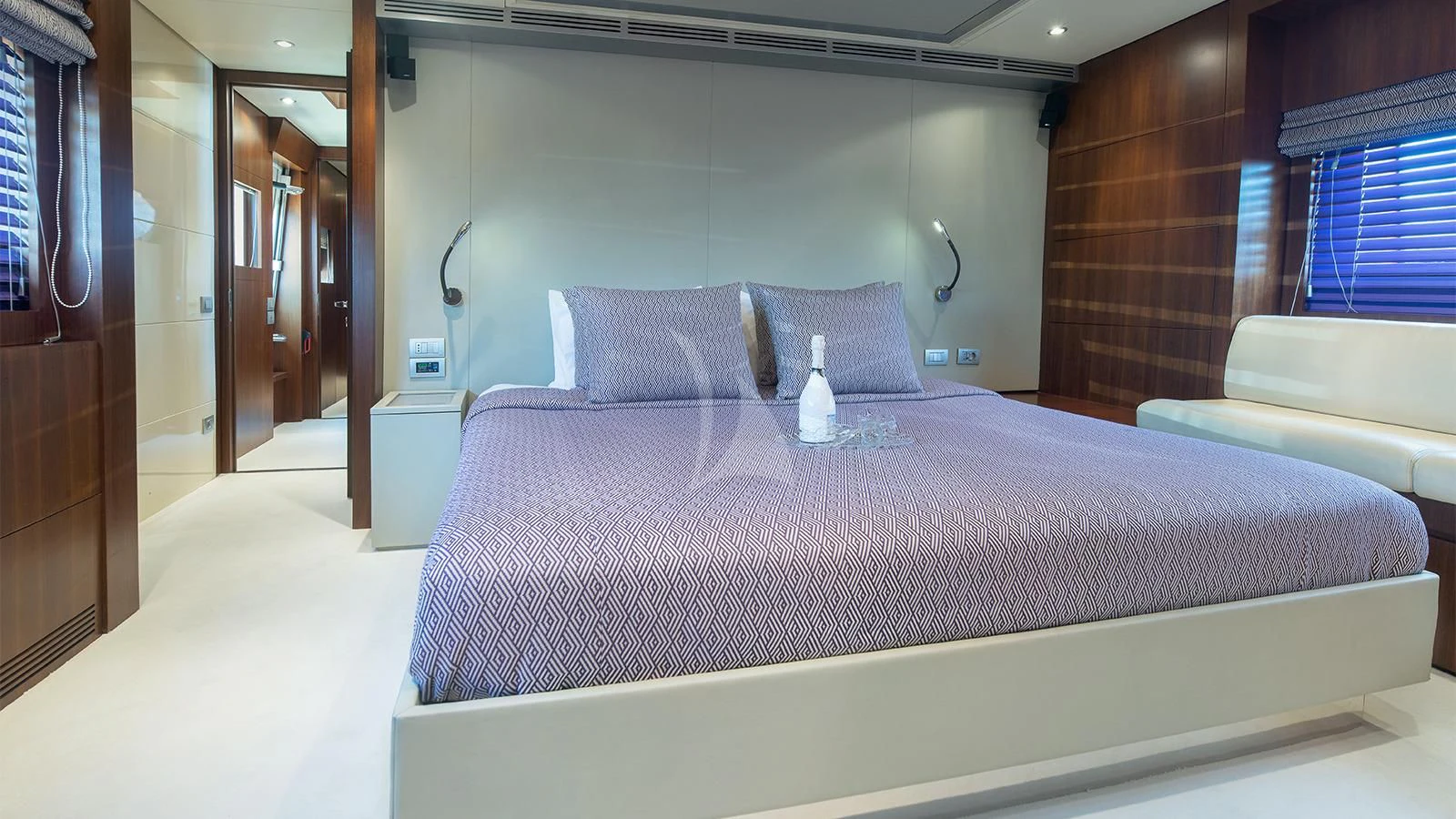 a bed with white sheets aboard BEYOND Yacht for Charter