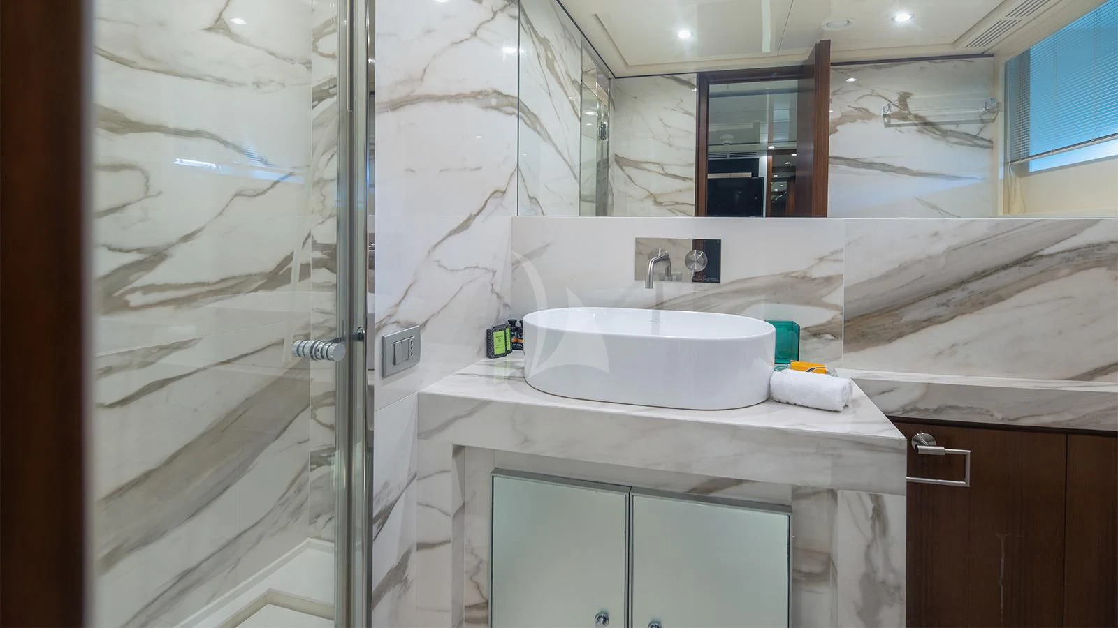 a bathroom with a sink and a mirror aboard BEYOND Yacht for Charter