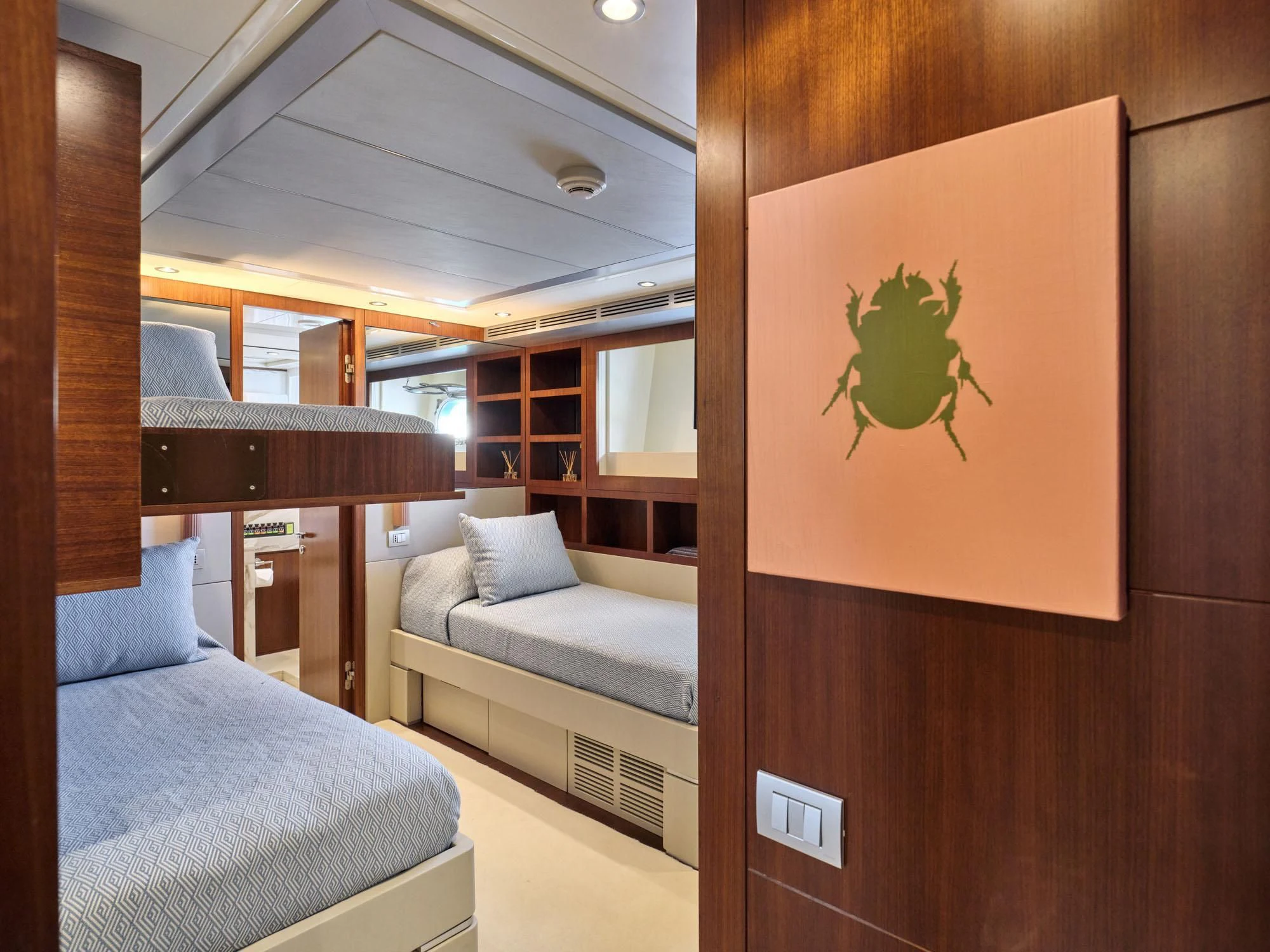 a room with a bed and a desk aboard BEYOND Yacht for Charter