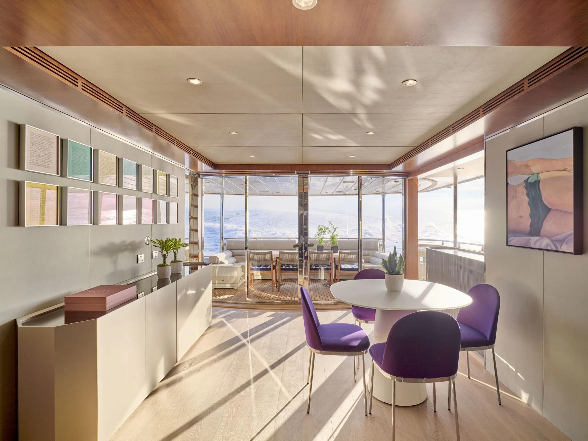 a room with a table and chairs aboard BEYOND Yacht for Charter