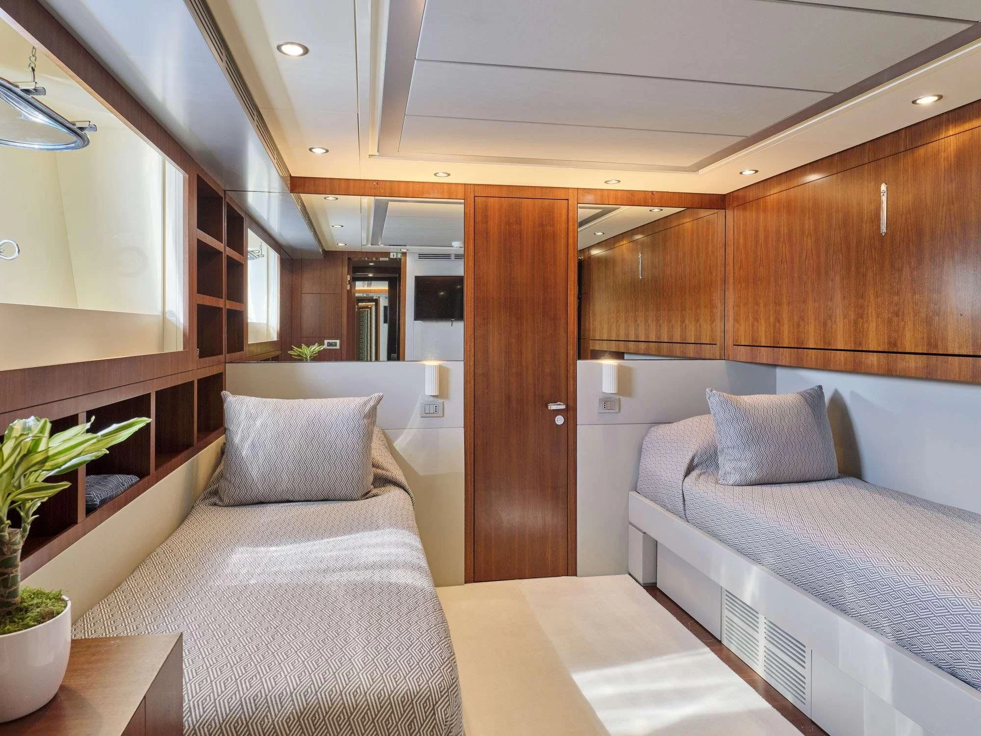 a room with a couple of beds aboard BEYOND Yacht for Charter