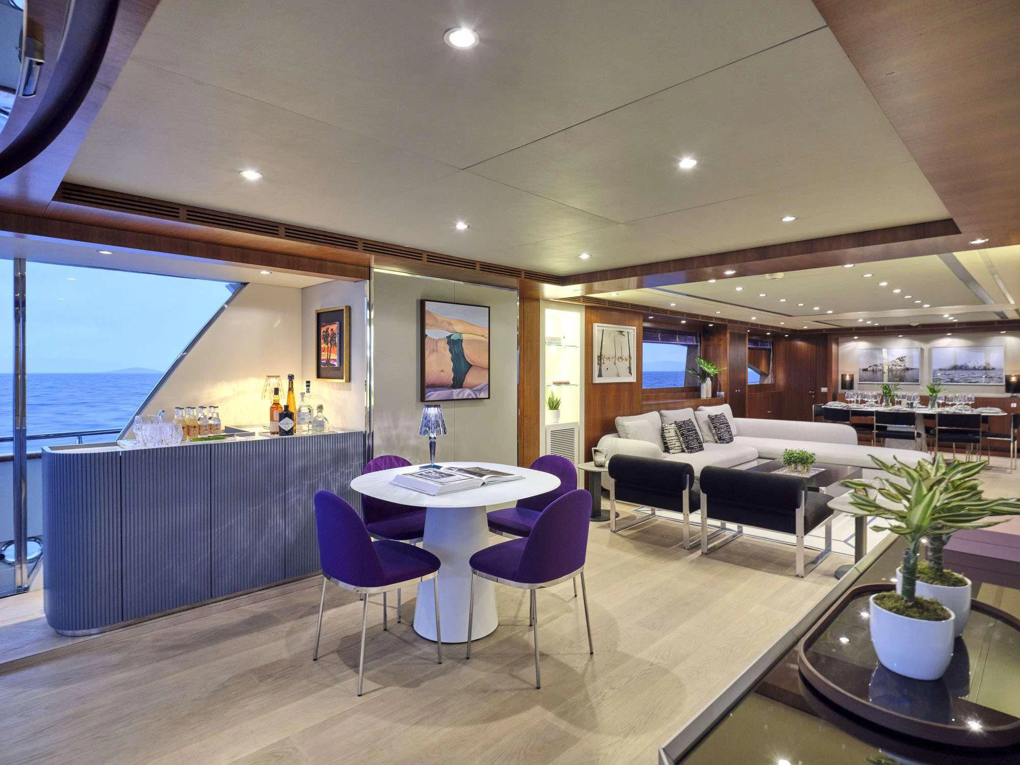 a living room with a table and chairs aboard BEYOND Yacht for Charter