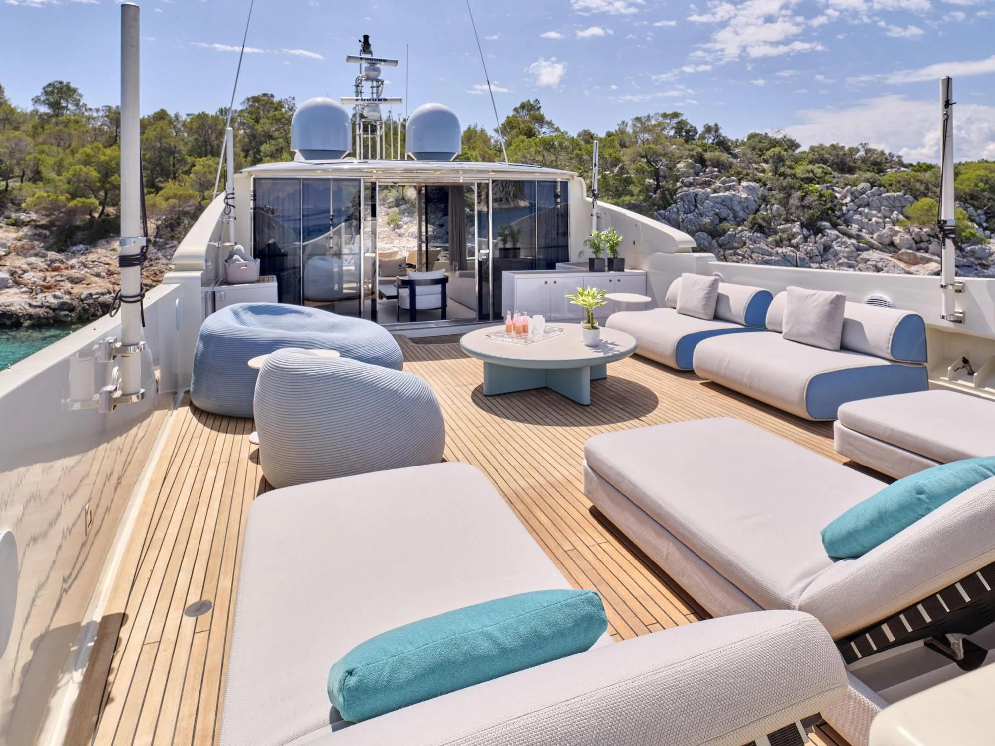 a large patio with a large glass window overlooking a city aboard BEYOND Yacht for Charter