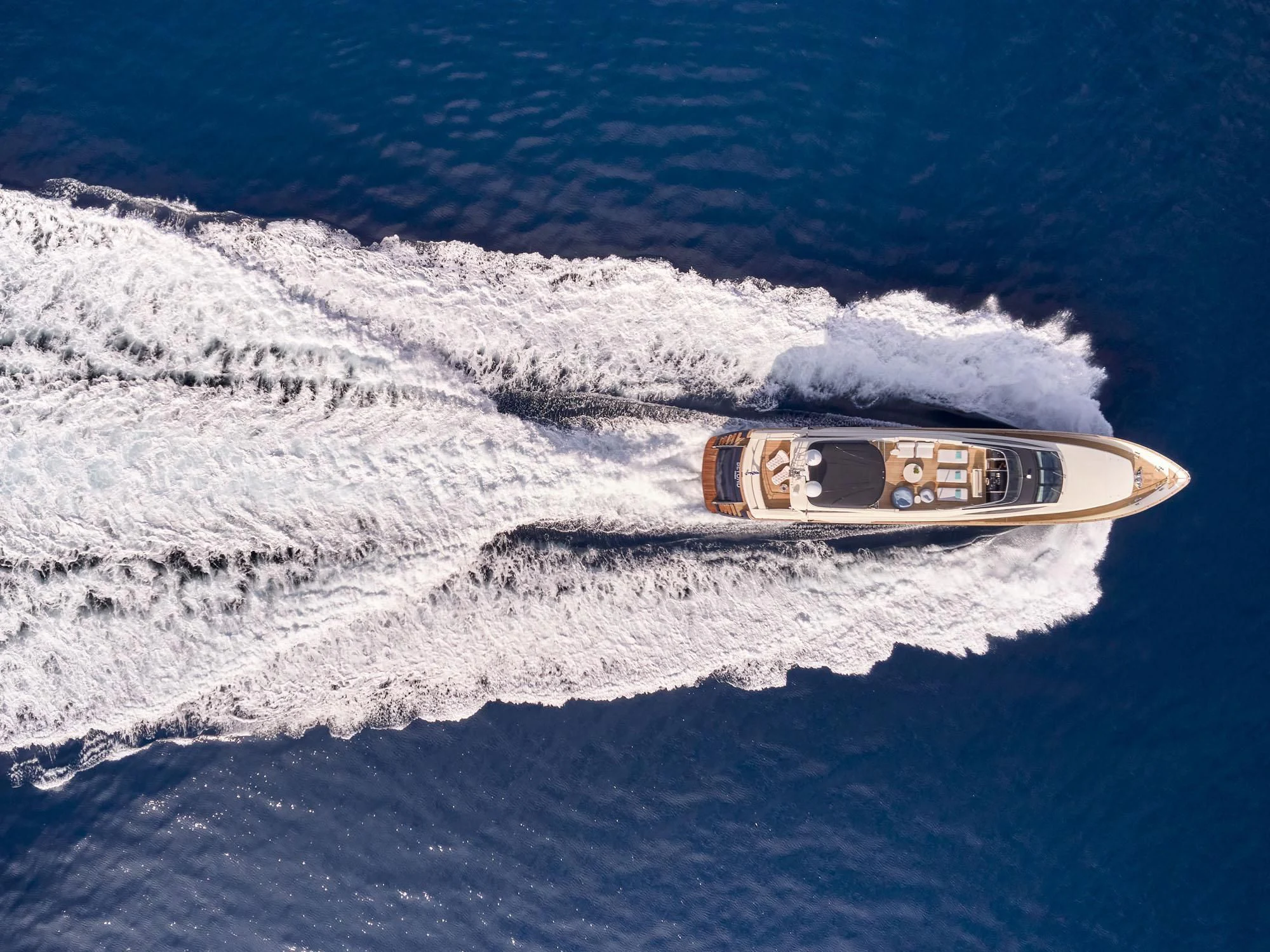 a bottle of alcohol on a beach aboard BEYOND Yacht for Charter