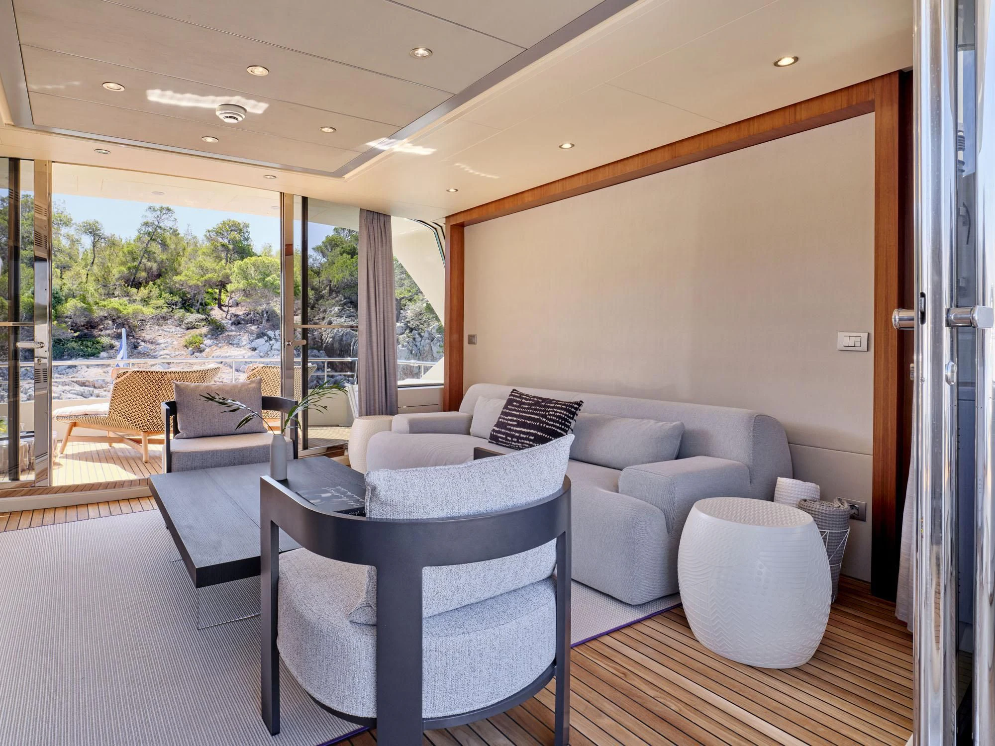 a living room with a large window aboard BEYOND Yacht for Charter
