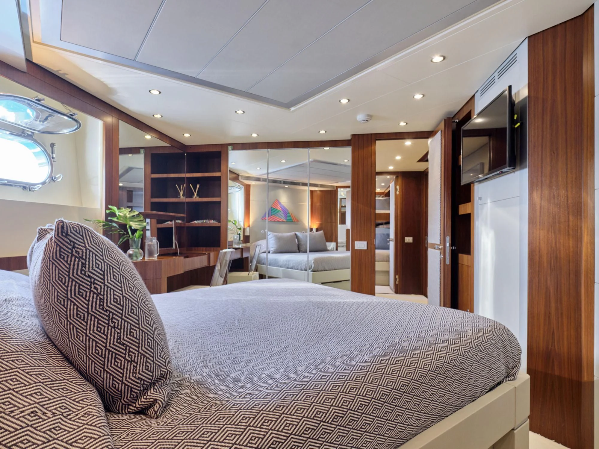 a large living room with a large bed and a large window aboard BEYOND Yacht for Charter