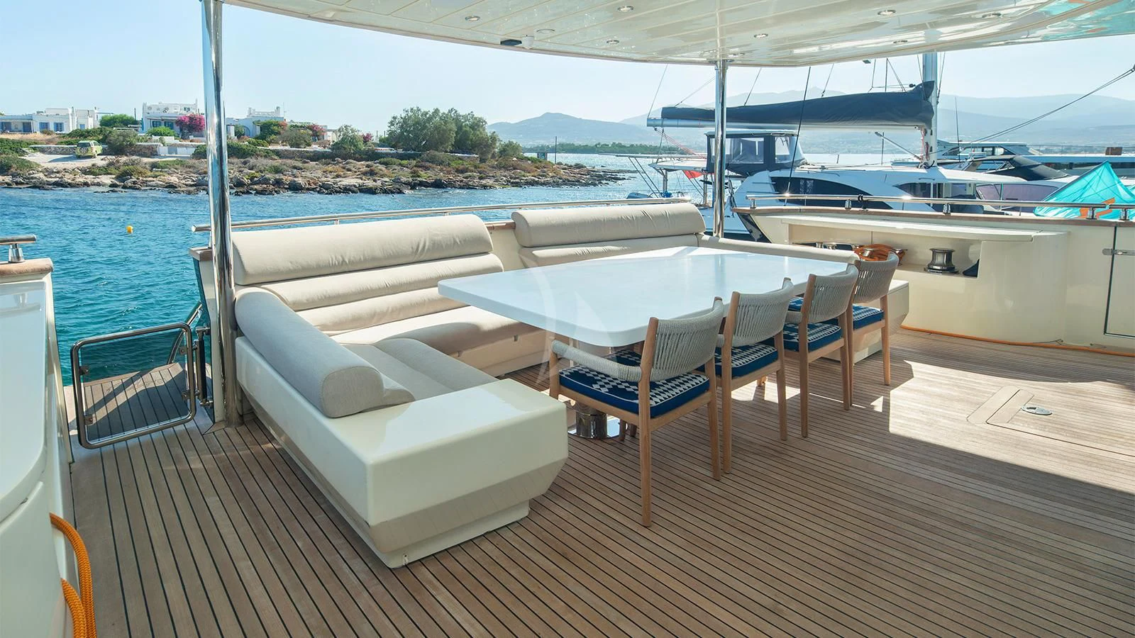 a deck with lounge chairs and tables aboard BEYOND Yacht for Charter