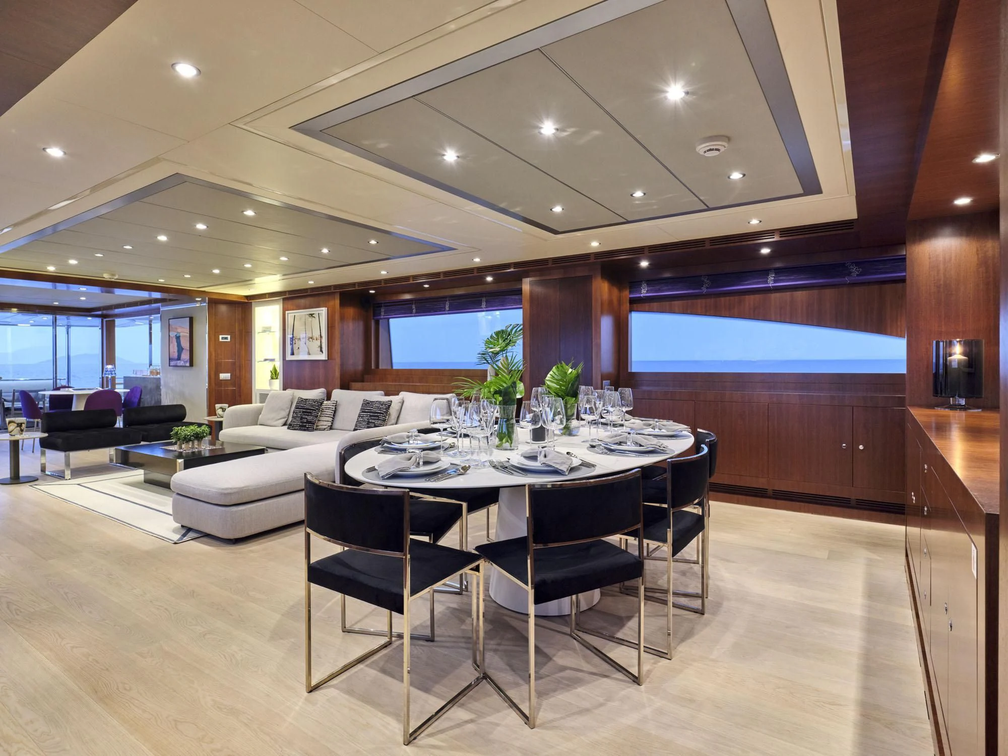 a large room with a table and chairs aboard BEYOND Yacht for Charter