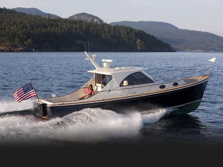 a boat with a flag on it aboard PIONEER Yacht for Sale