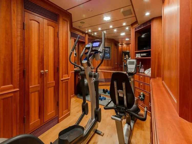 a gym with equipment aboard PIONEER Yacht for Sale