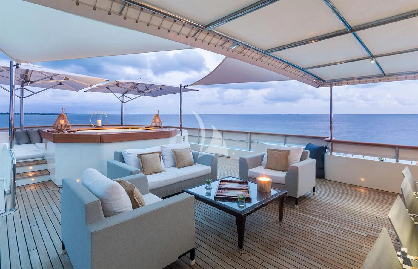 a room with a couch and a table and a large body of water aboard PIONEER Yacht for Sale