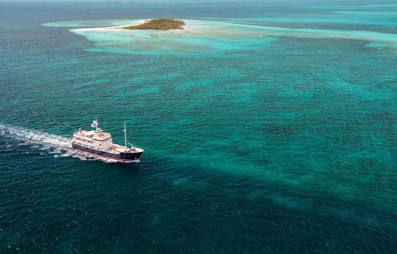 a ship in the ocean aboard PIONEER Yacht for Sale