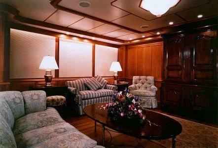 a living room with a couch and a coffee table aboard PIONEER Yacht for Sale