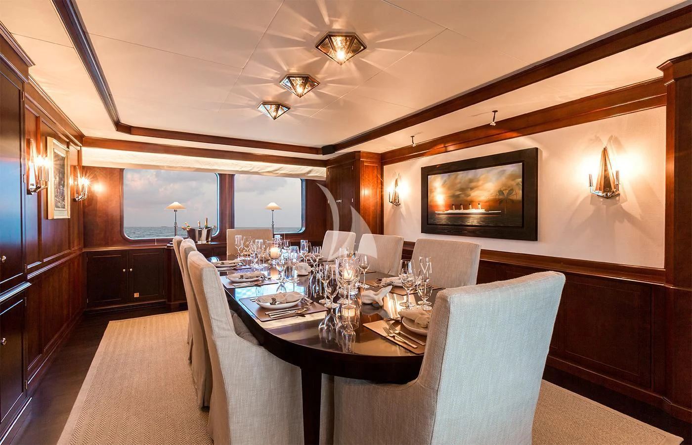 a dining room with a table set for a dinner aboard PIONEER Yacht for Sale