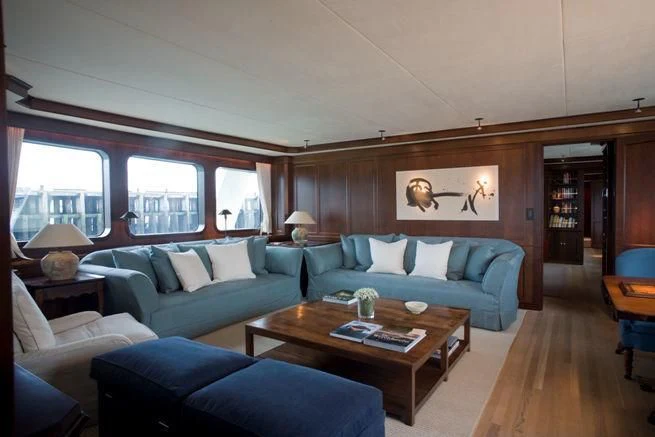 a living room with a couch and a coffee table aboard PIONEER Yacht for Sale