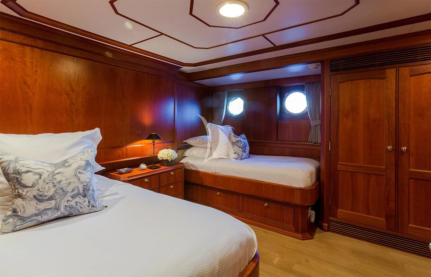 a bedroom with a bed and a dresser aboard PIONEER Yacht for Sale
