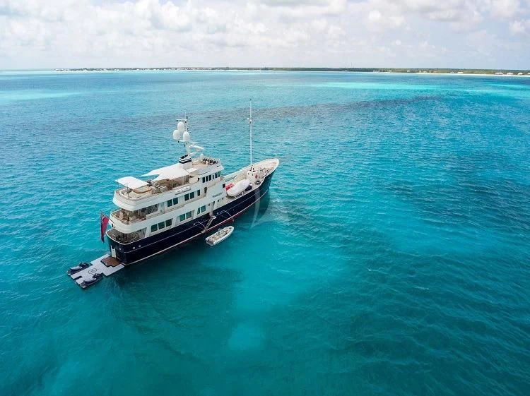 a large ship in the water aboard PIONEER Yacht for Sale