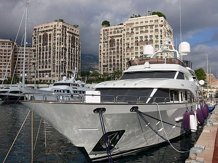 a large white boat sits in a harbor aboard RENAISSANCE Yacht for Sale